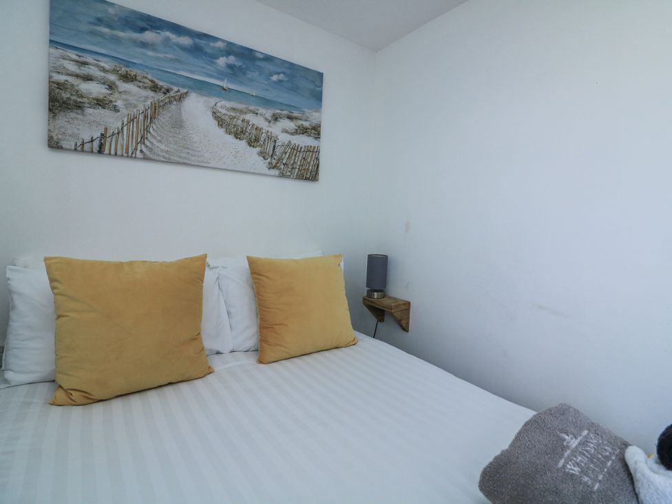 A bedroom with a bed and pillows at Sunset Sea View Chalet Millbrook