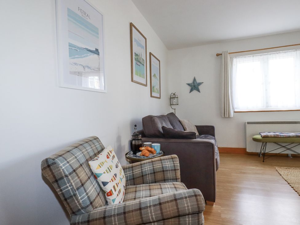 A living room with chairs and a sofa at Flat 4 in Newquay