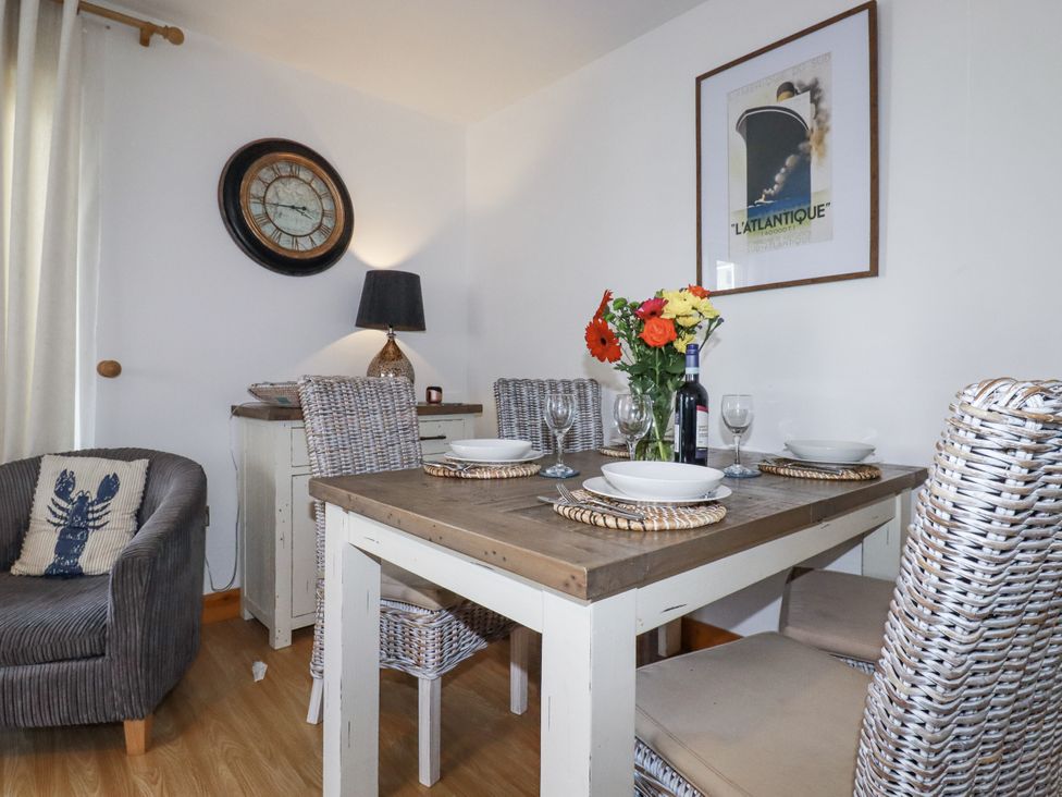 A dining room with a table set for dinner at Flat 4 in Newquay