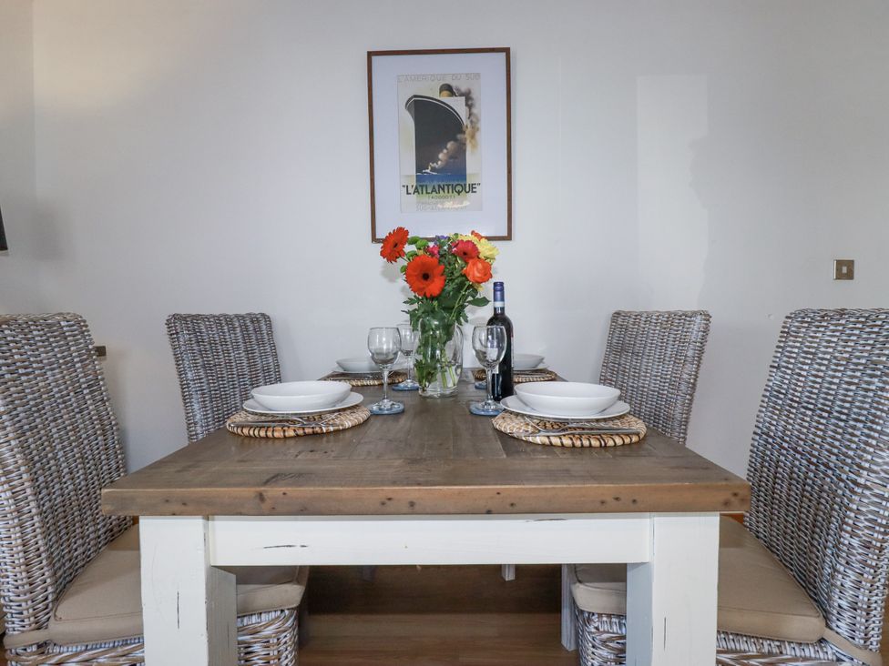 A dining room with a table set for four at Flat 4 in Newquay