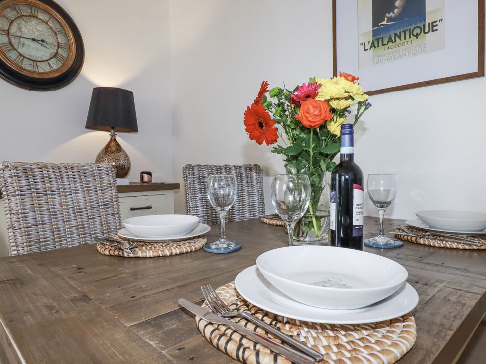 A dining room with a table set for dinner at Flat 4 in Newquay