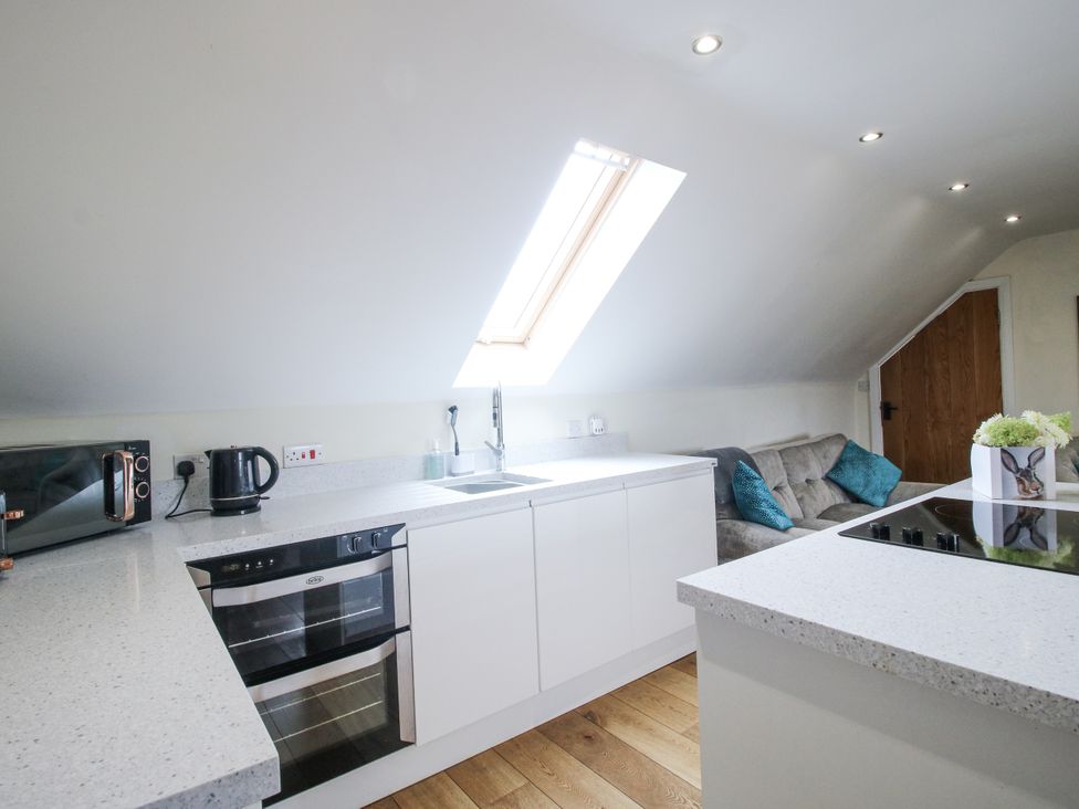 A kitchen with a sink and oven at Stable Cottage in Norbury near Bishop's Castle