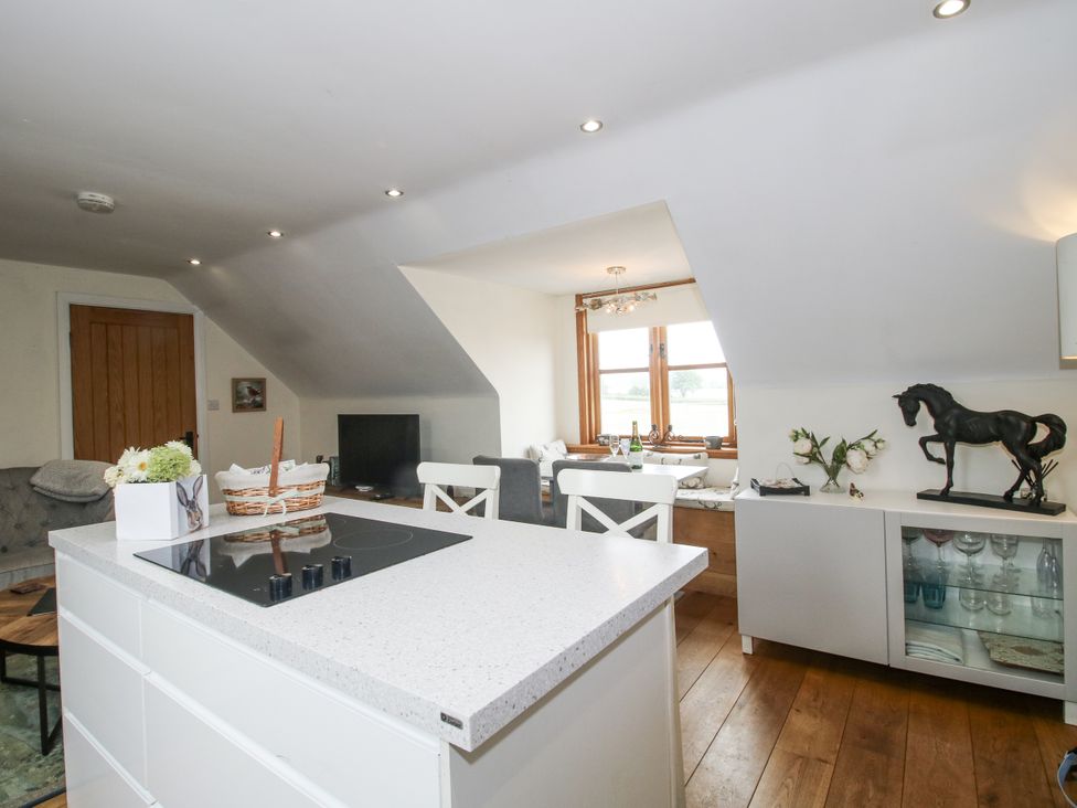 A kitchen with a dining area and living space at Stable Cottage in Norbury near Bishop's Castle