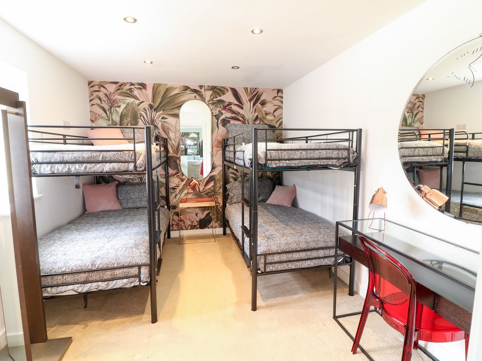 A bedroom with bunk beds and a desk at Hideaway in Scampton
