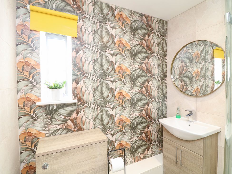 A bathroom with a sink and a window at Hideaway in Scampton