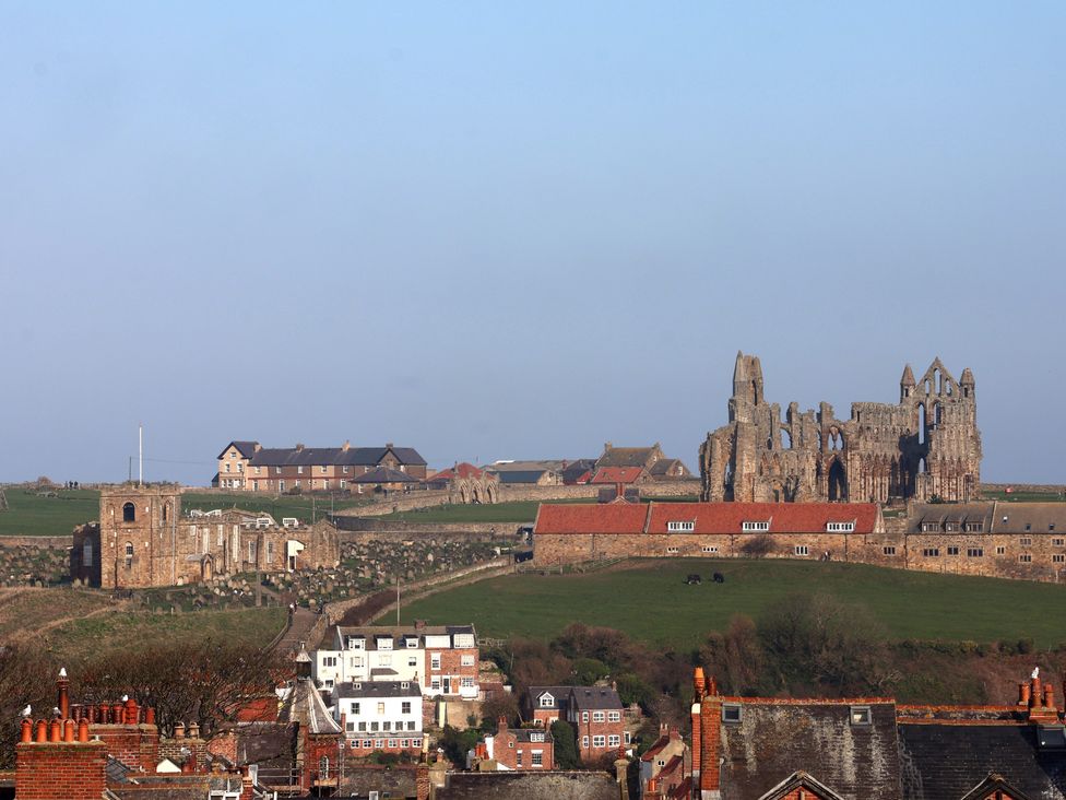 A landscape view with ruins and houses at Sunset View in Whitby