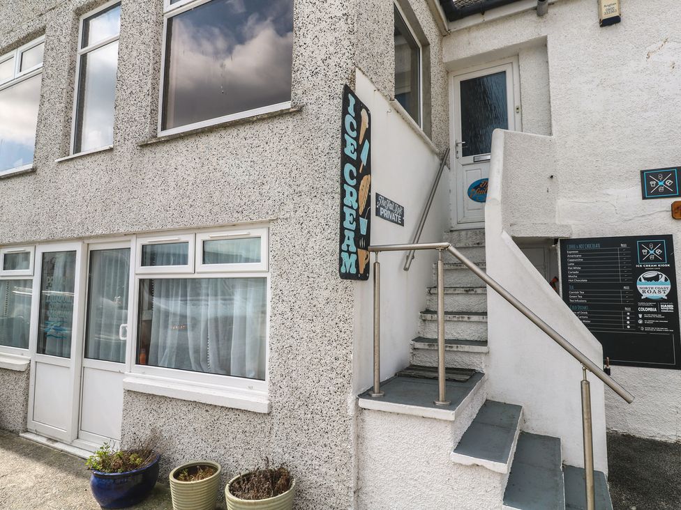 An outdoor area with stairs and an ice cream sign at Harbour Studio in Sennen Cove