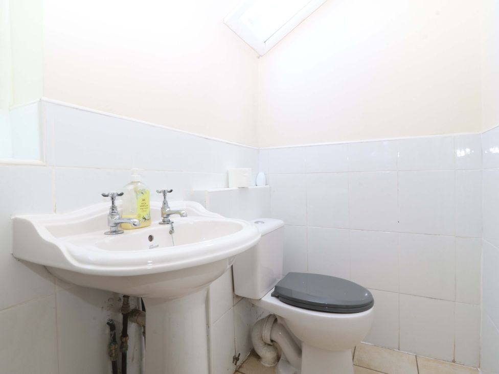 A bathroom with a sink and toilet at Cwm Eilir in Criccieth