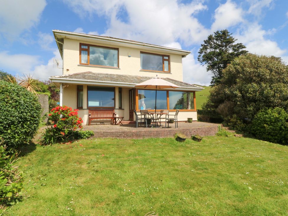 A house with a garden and outdoor seating at Cwm Eilir in Criccieth