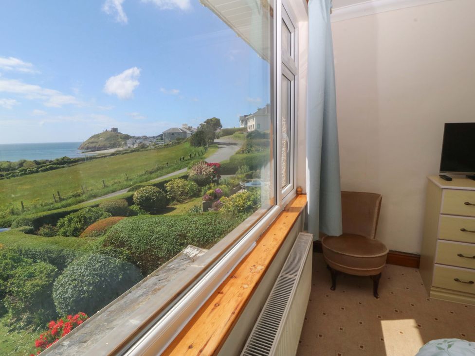 A bedroom with a view of the landscape at Cwm Eilir in Criccieth