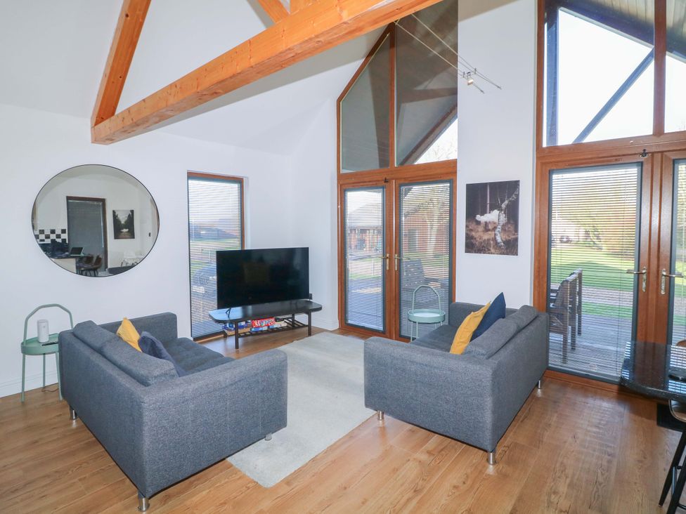 A living room with sofas and a TV at Lodge 1 South Hykeham