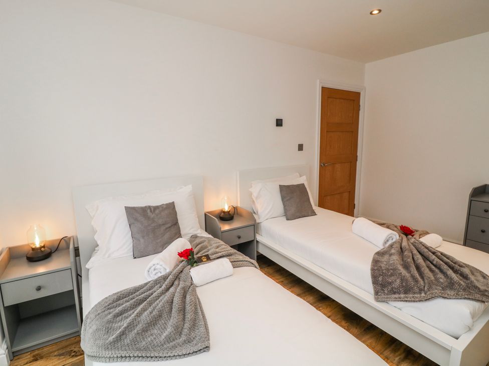 A bedroom with two beds and bedside tables at Lodge 24 in South Hykeham