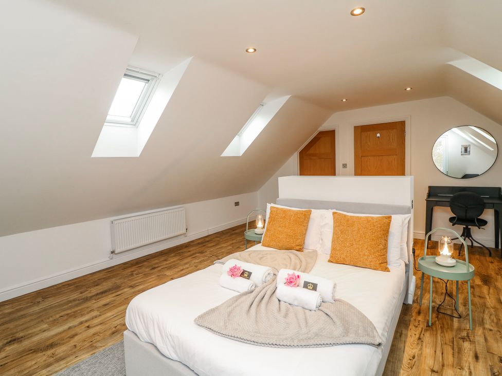 A bedroom with a bed and side tables at Lodge 24 in South Hykeham