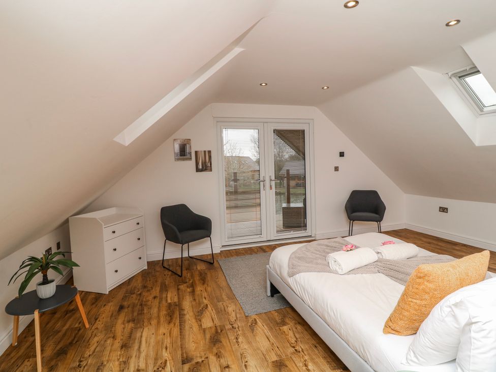 A bedroom with a bed and furniture at Lodge 24 South Hykeham