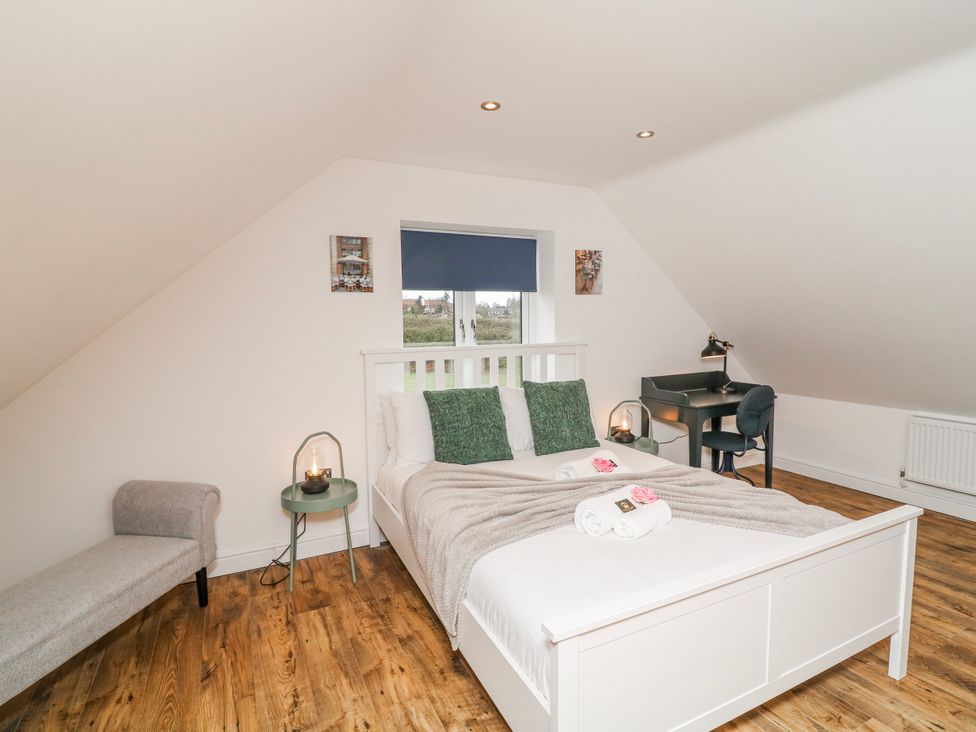 A bedroom with a bed and a desk at Lodge 24 in South Hykeham