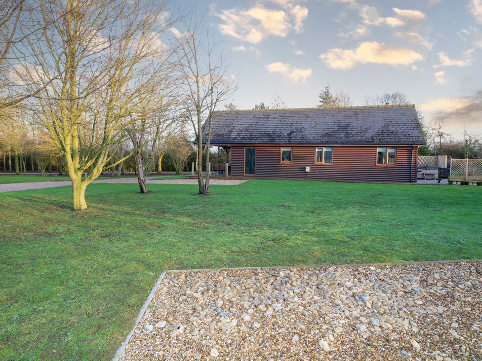 A house with trees and a grassy area at Lodge 2 South Hykeham
