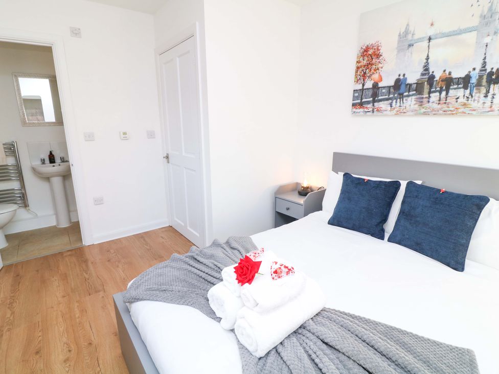 A bedroom with a bed and attached bathroom at Lodge 2 in South Hykeham