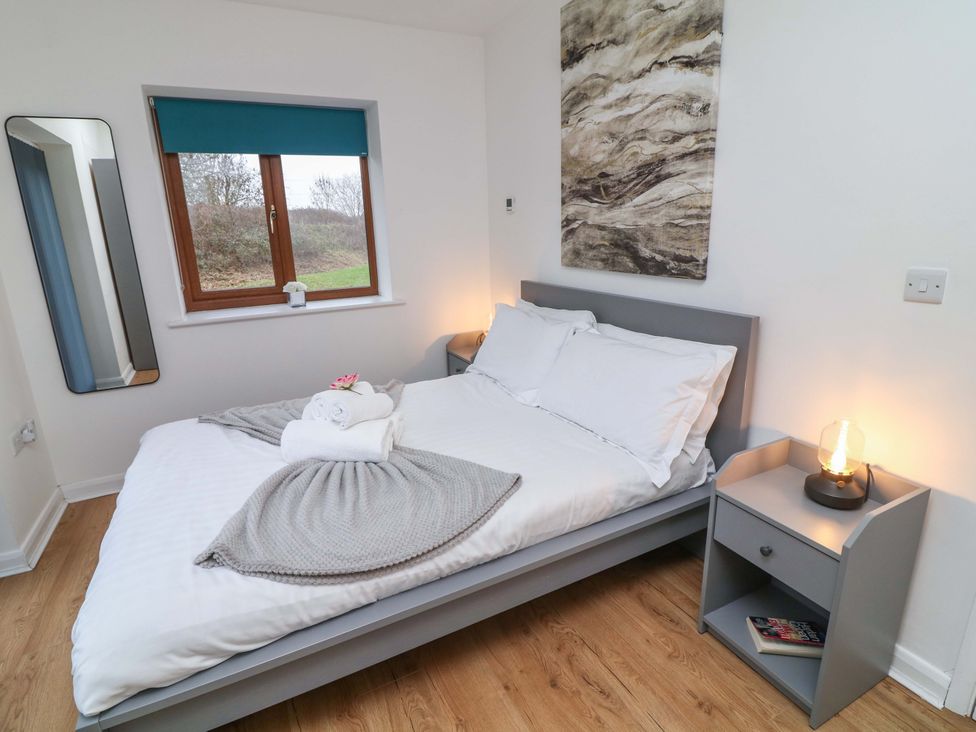 A bedroom with a bed and window at Lodge 4 South Hykeham