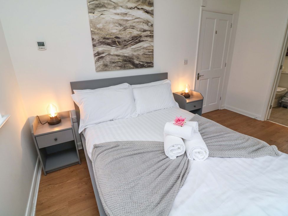 A bedroom with a bed and bedside table at Lodge 4 South Hykeham