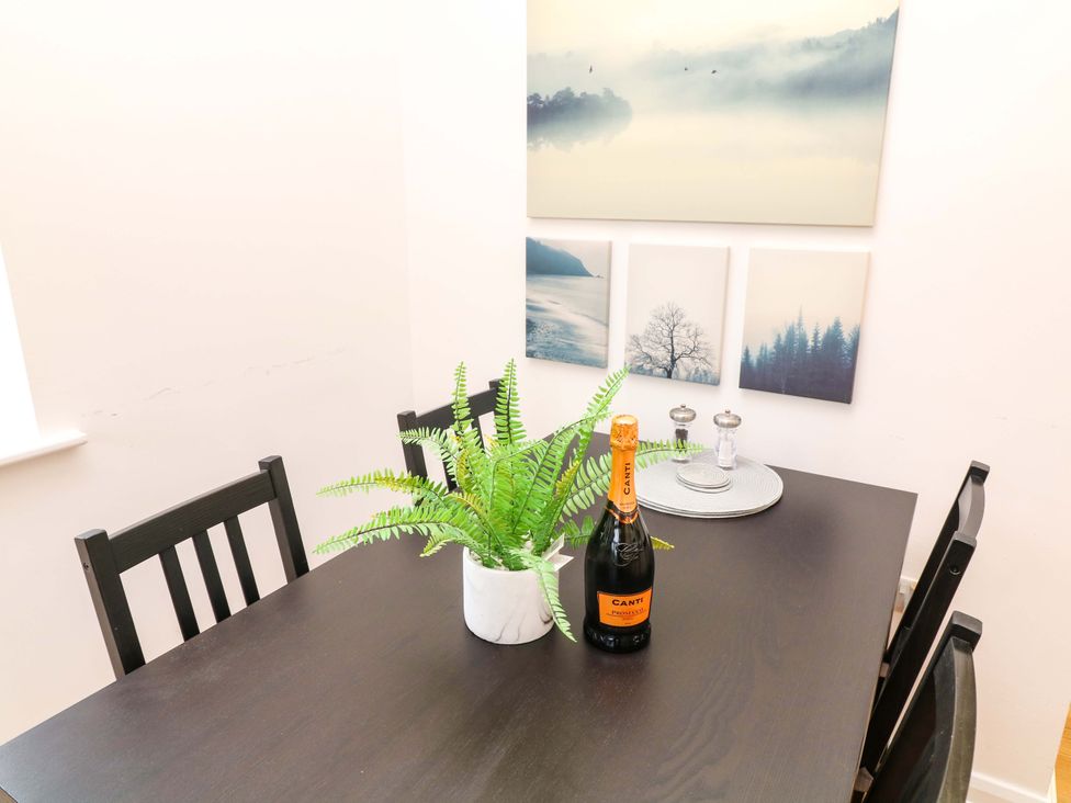 A dining room with a table and chairs at Lodge 7 South Hykeham