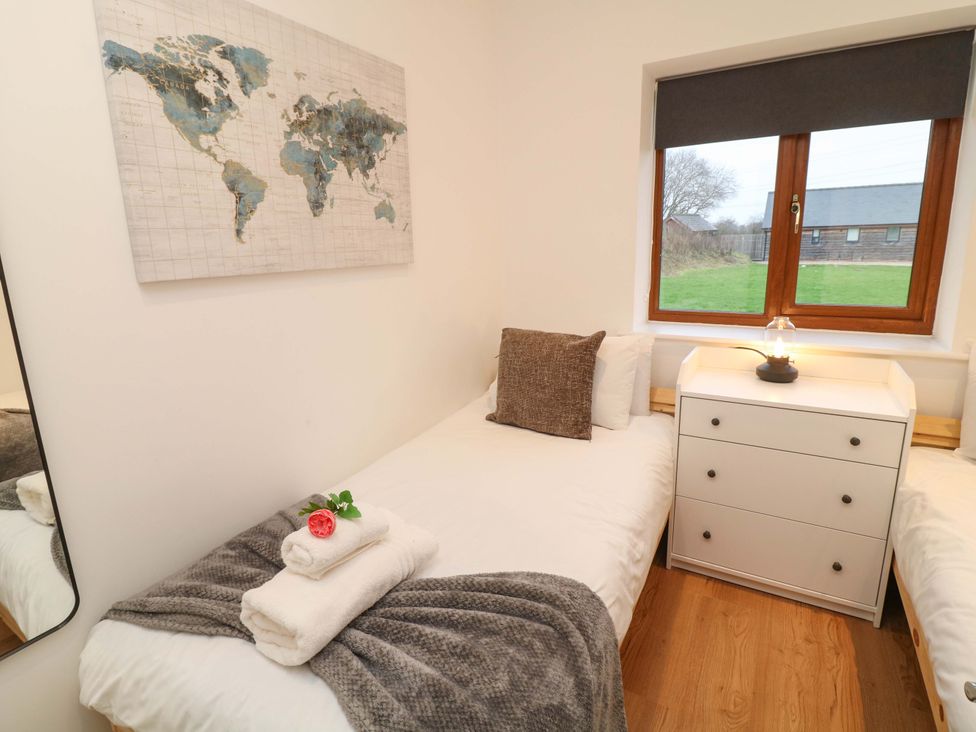 A bedroom with two beds and a map on the wall at Lodge 7 in South Hykeham