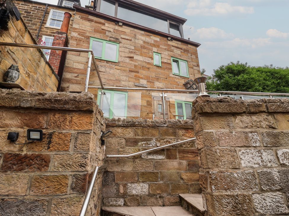 An exterior view of a house with stairs at 5 Hall Yard in Whitby