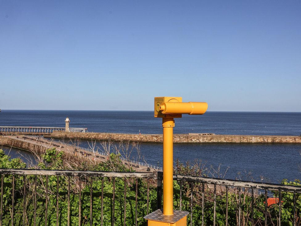 A viewing telescope overlooking the ocean and pier at 5 Hall Yard Whitby