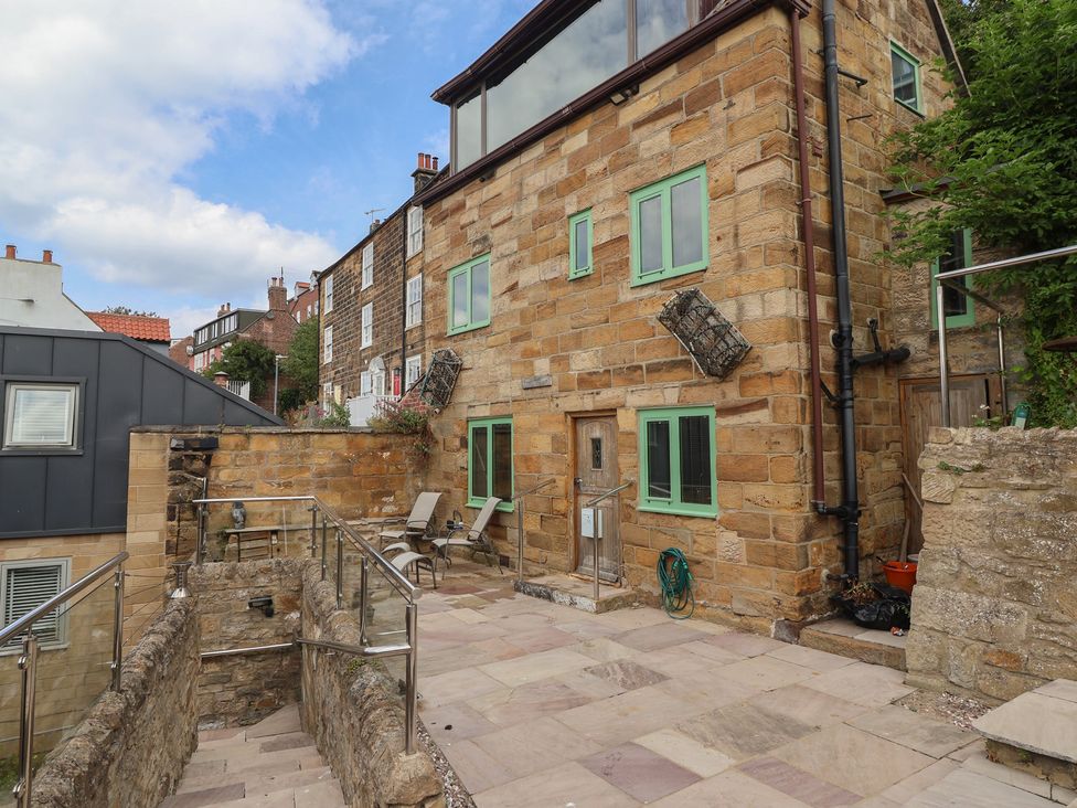 An outdoor area with a stone building and patio at 5 Hall Yard in Whitby