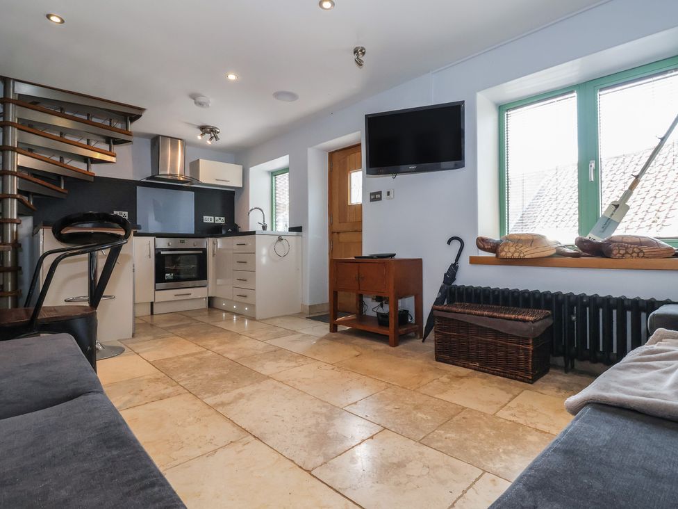 A kitchen with appliances and furniture at 5 Hall Yard in Whitby
