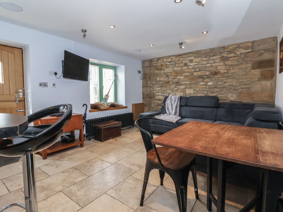 A living room with a sofa and table at 5 Hall Yard in Whitby