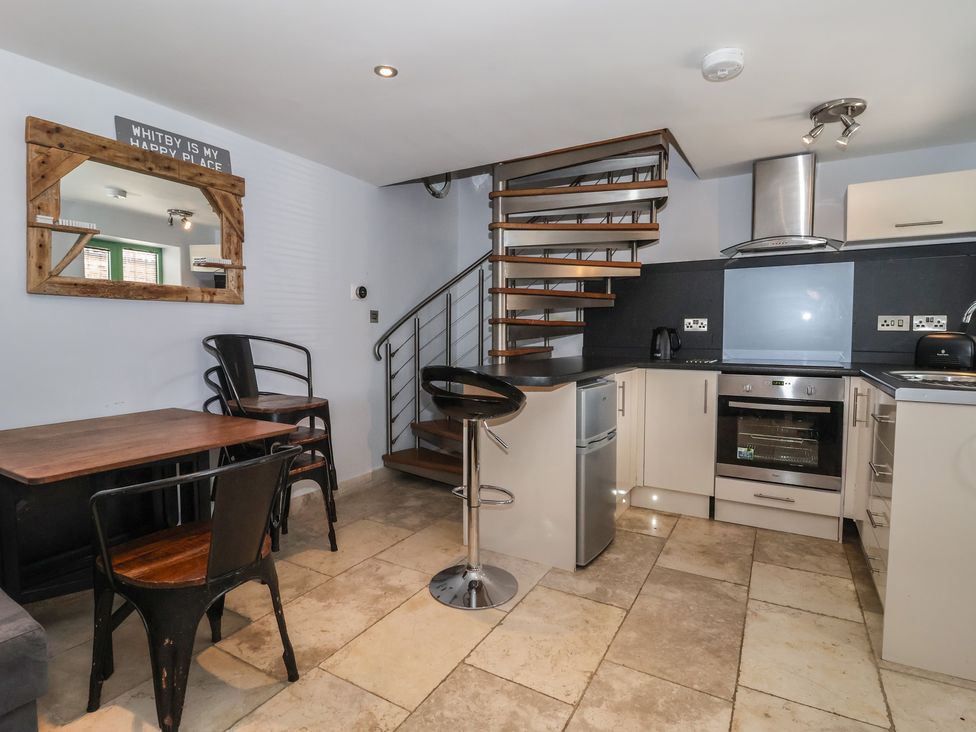 A kitchen with a dining table and chairs at 5 Hall Yard in Whitby