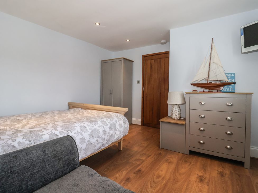 A bedroom with a bed and chest of drawers at 5 Hall Yard in Whitby
