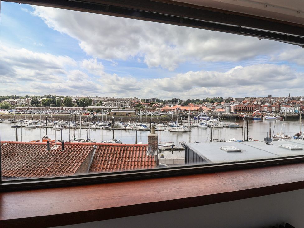 A view of a marina with boats from a window at 5 Hall Yard in Whitby
