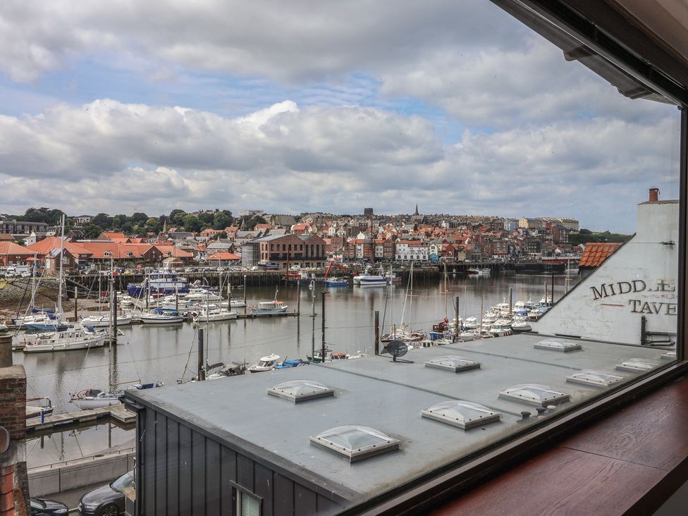 A view of boats and buildings by the water at 5 Hall Yard in Whitby