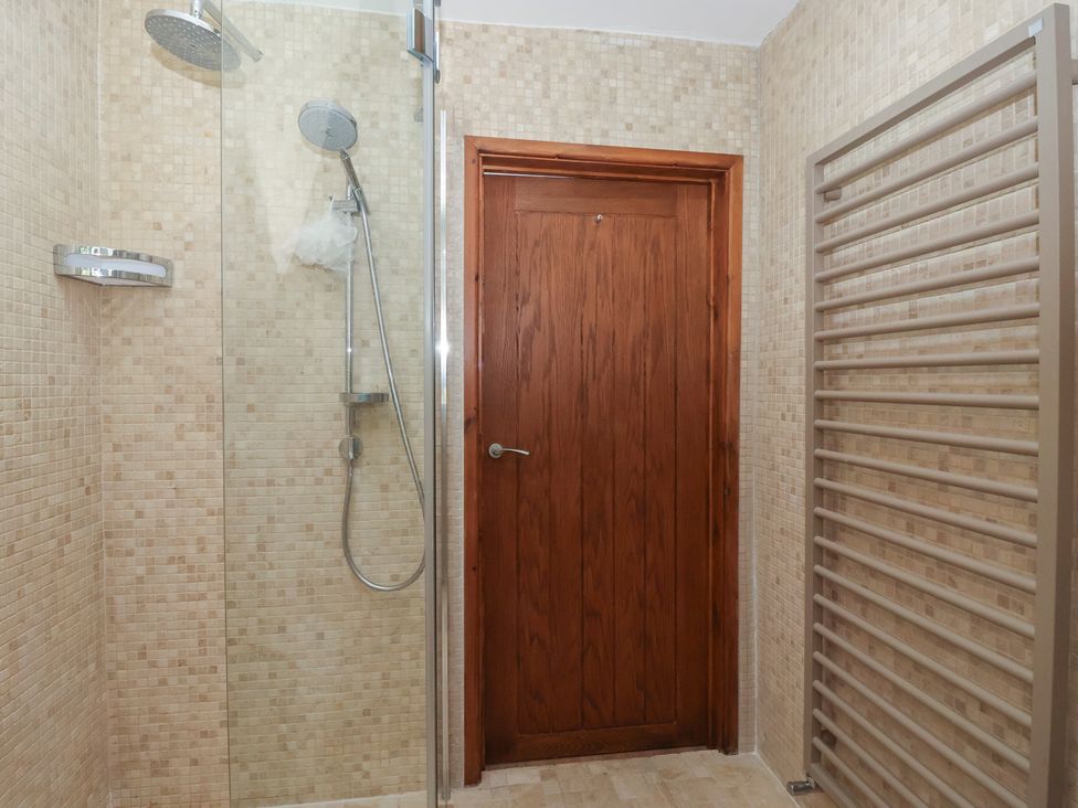 A bathroom with a shower and towel radiator at 5 Hall Yard in Whitby