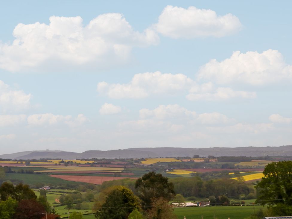 A landscape featuring fields, hills, and clouds at Palace Bungalow St Weonards