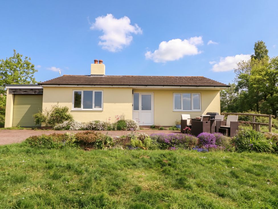 A bungalow with patio furniture and garden at Palace Bungalow St Weonards