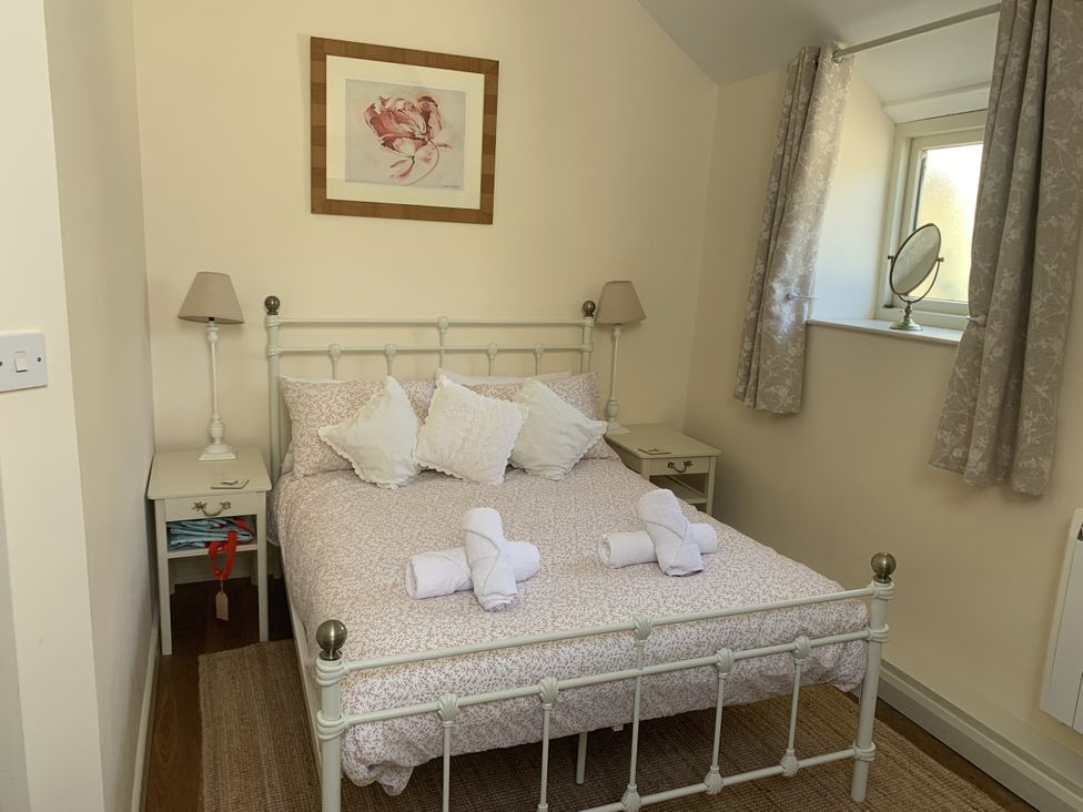 A bedroom with a double bed and bedside tables at The Calf Pen in Colyton