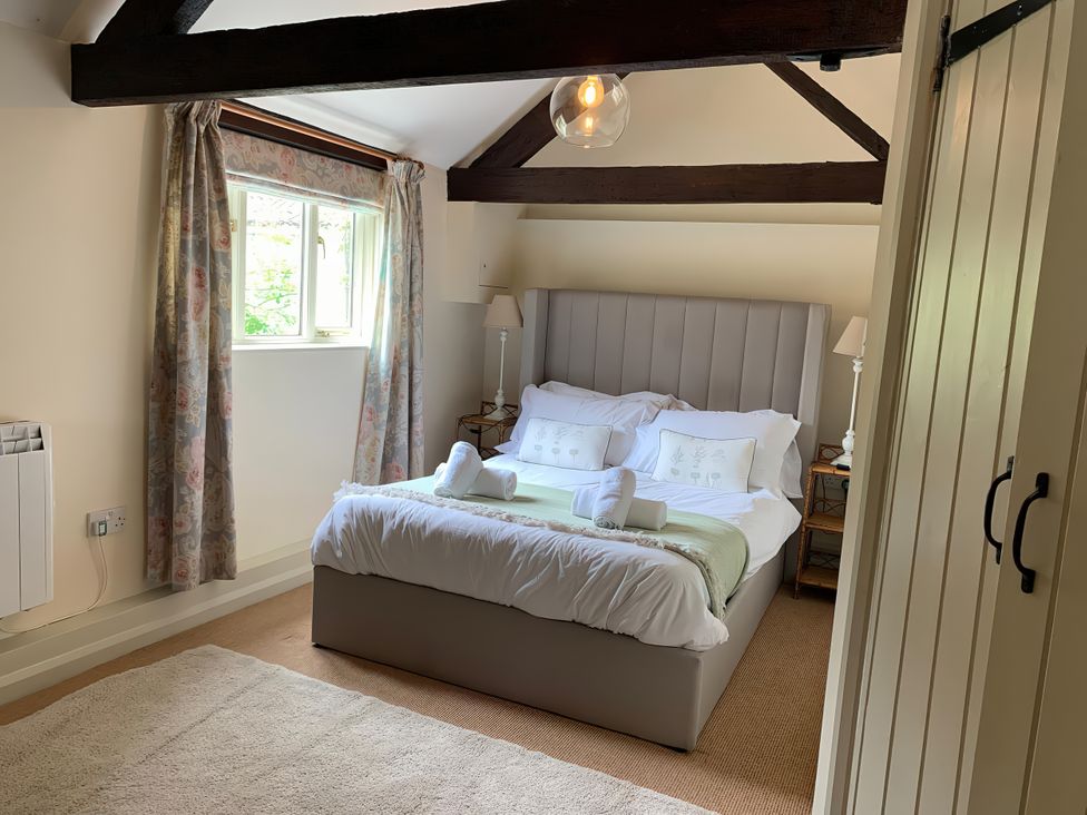 A bedroom with a bed and bedside tables at The Bull Pen in Colyton