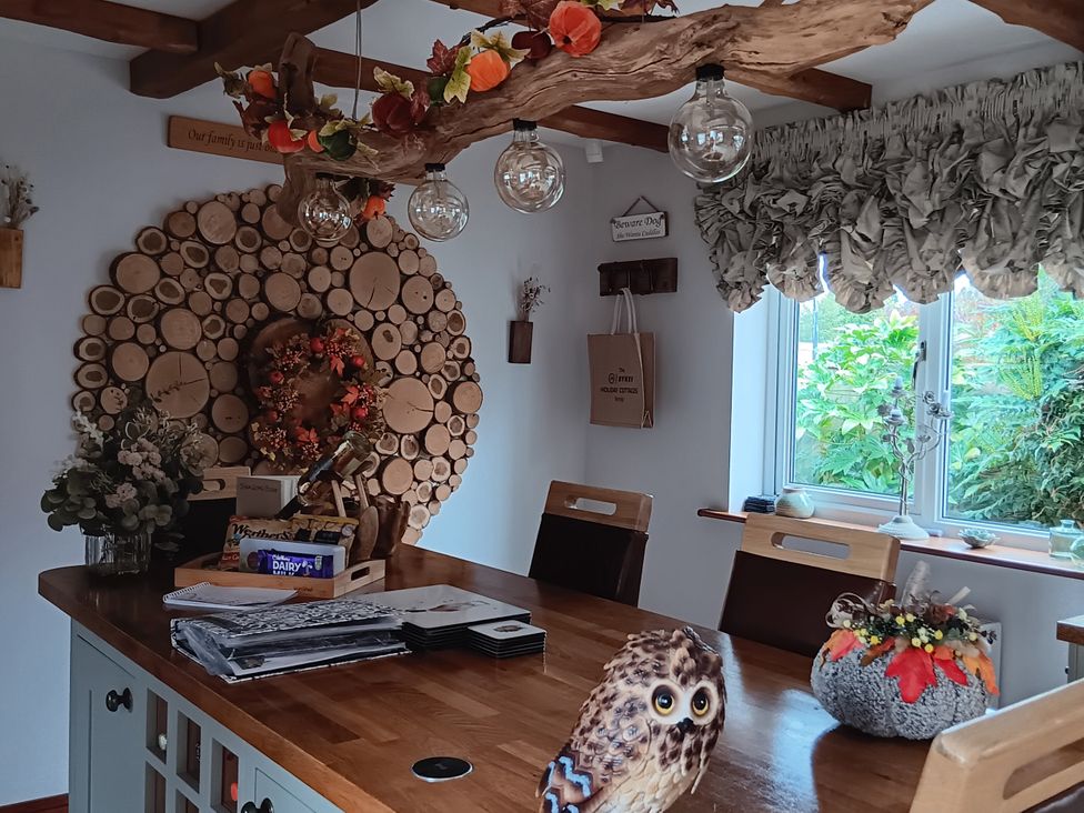 A kitchen with wooden counter and light fixtures at Tawny Owl Cottage in North Somercotes