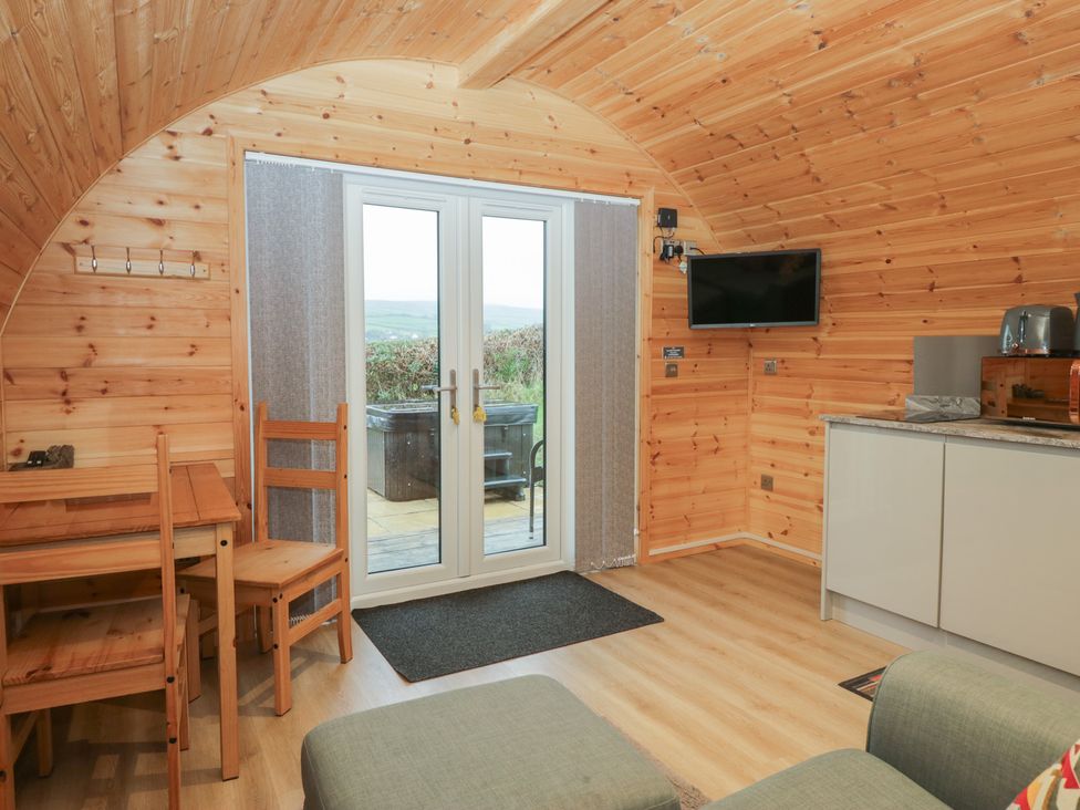 A living area with a table and chairs at Holly in Ulverston
