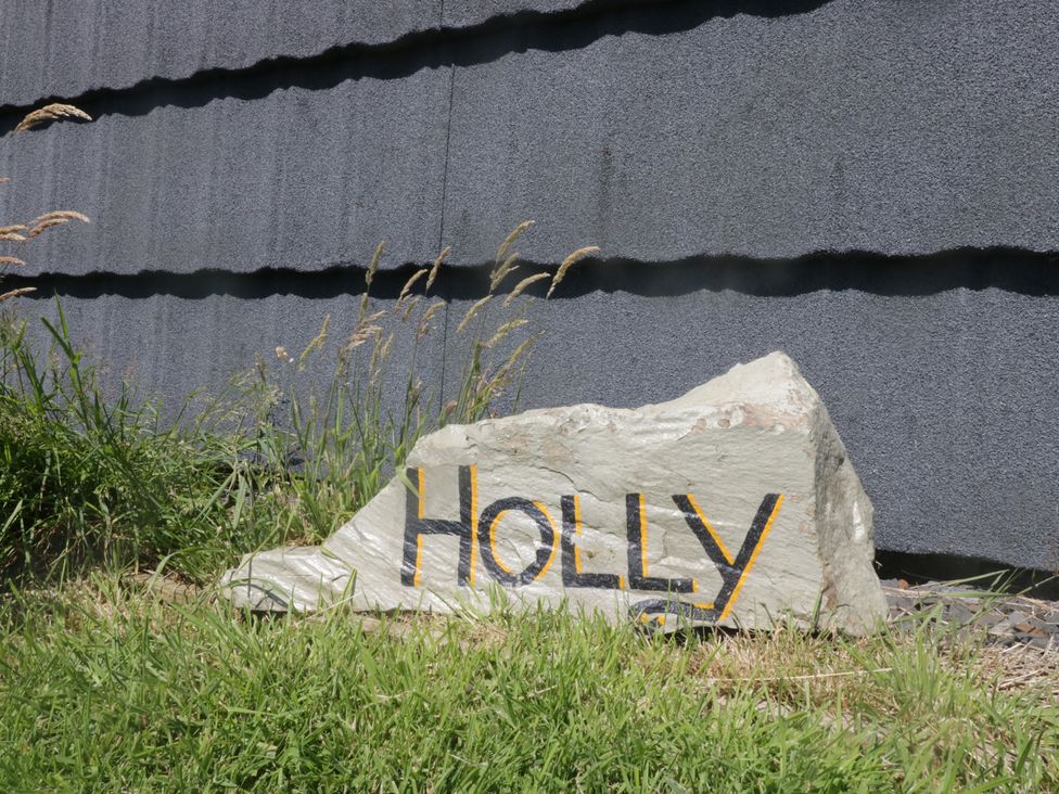 A rock with 'HOLLY' painted on it in an outdoor area at Holly in Ulverston