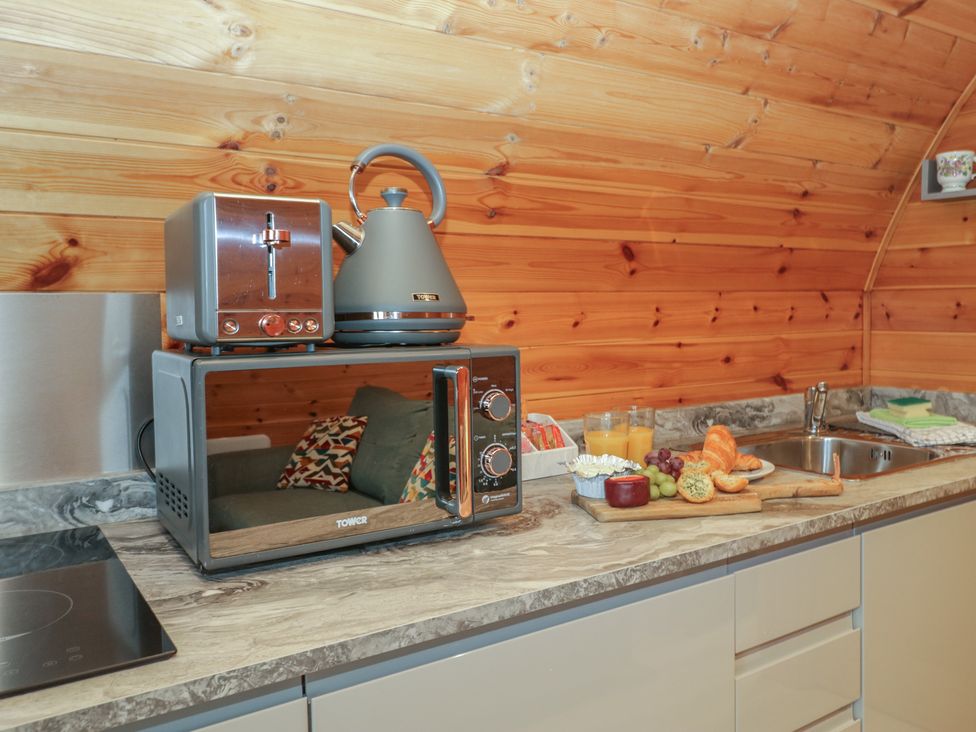 A kitchen with a microwave, kettle, and toaster at Willow in Ulverston