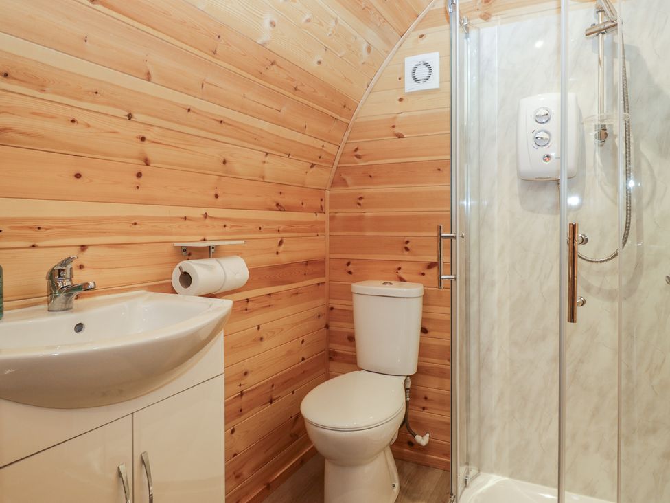 A bathroom with a sink, toilet, and shower at Willow in Ulverston