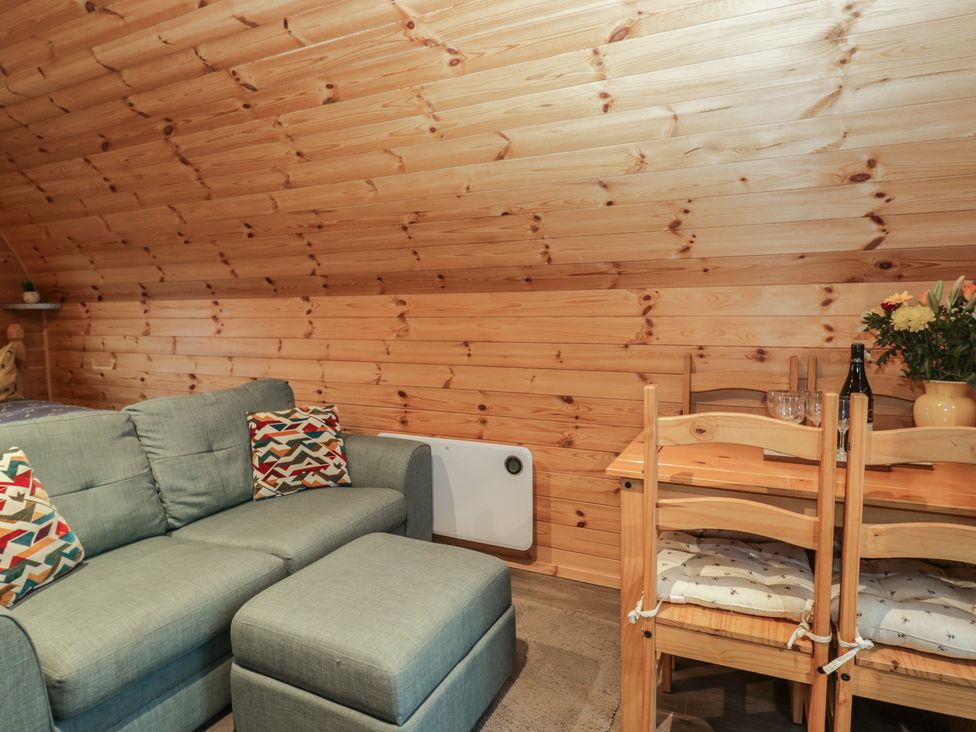 A snug with a sofa and dining table at Oak in Ulverston