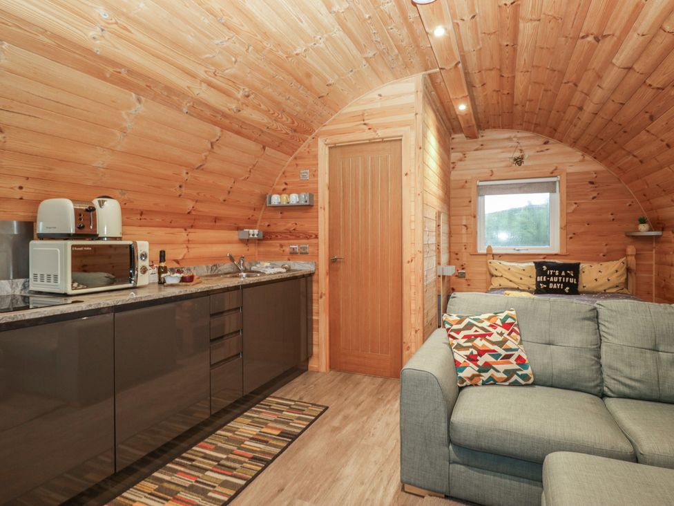 A kitchen with sofa and appliances at Oak in Ulverston