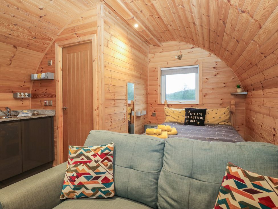 A bedroom with a bed and kitchenette at Oak in Ulverston