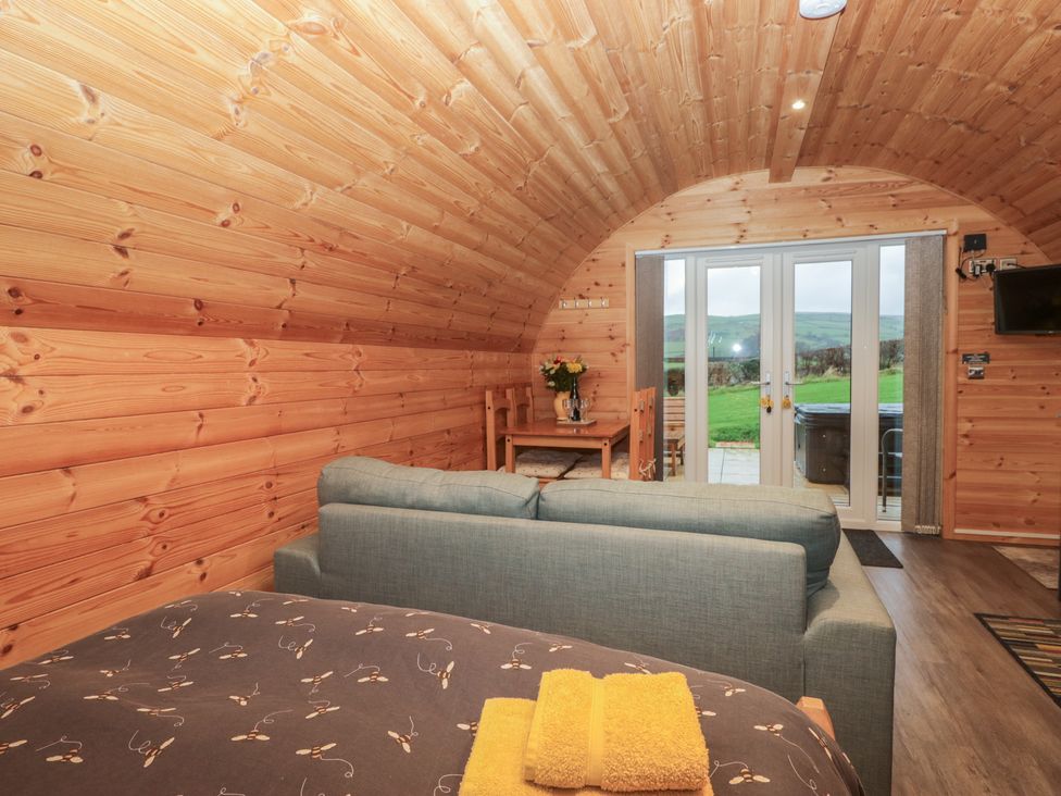 A living room with a sofa and dining area at Oak in Ulverston