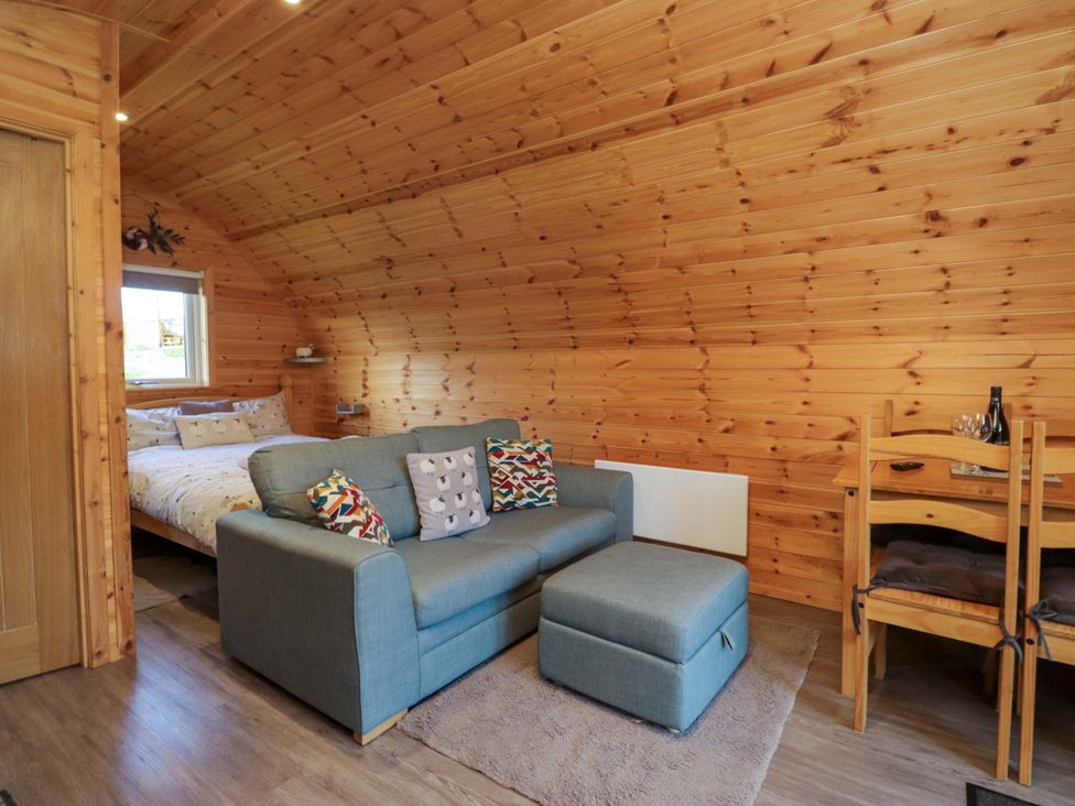 A living room with a sofa and table at Cherry in Ulverston