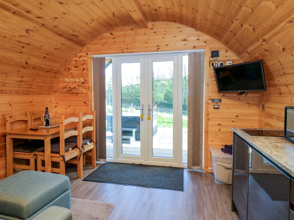 A living room with a table and chairs at Cherry in Ulverston
